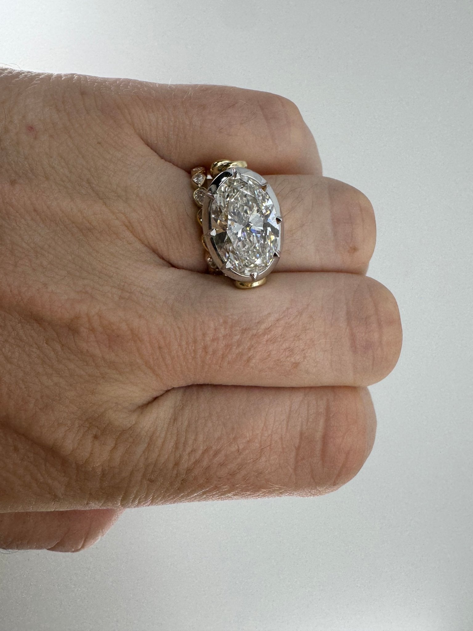 7 carat oval lab grown diamond engagement ring set in two tone collet - Jewelry by Cleo