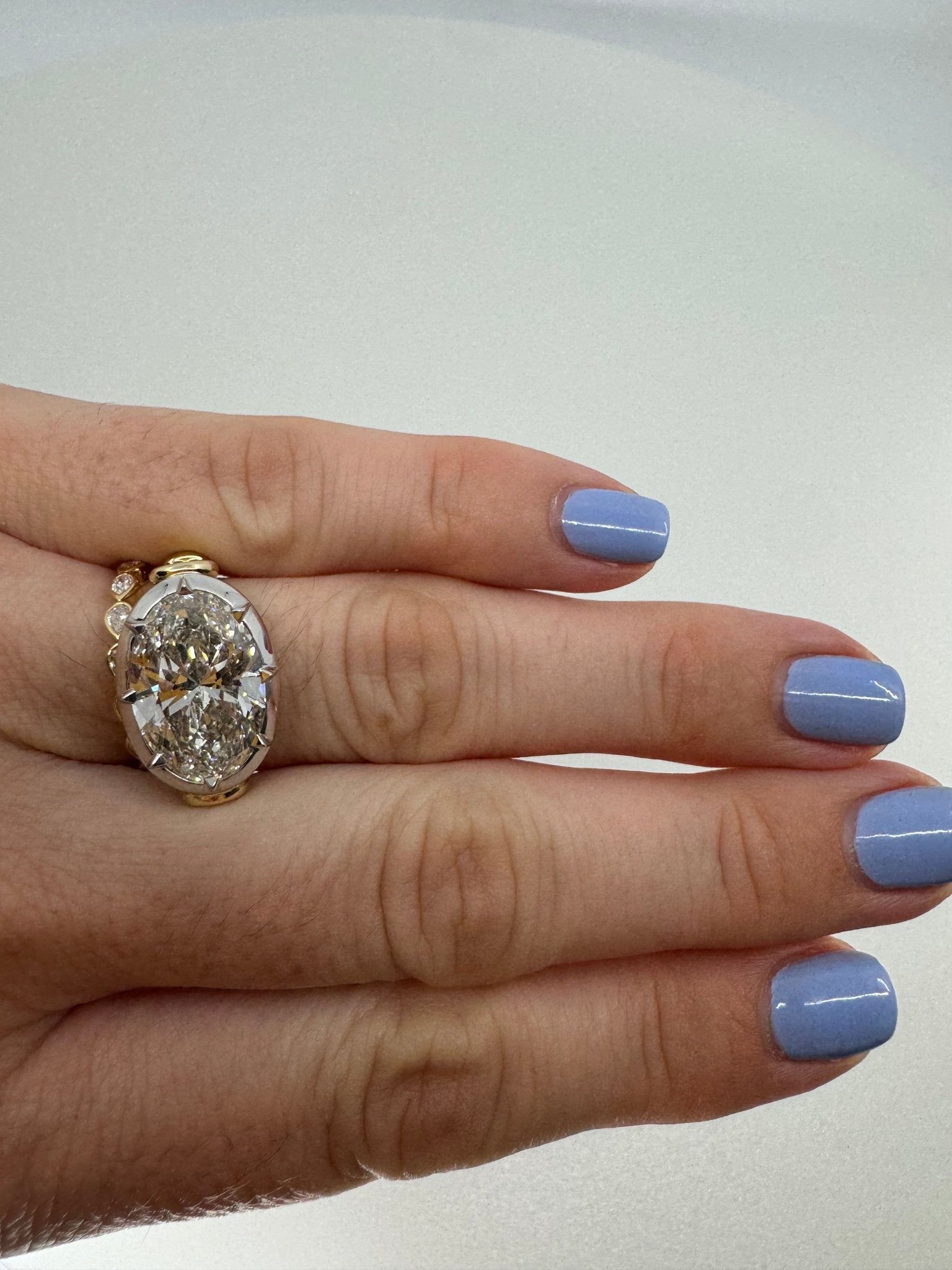 7 carat oval lab grown diamond engagement ring set in two tone collet - Jewelry by Cleo