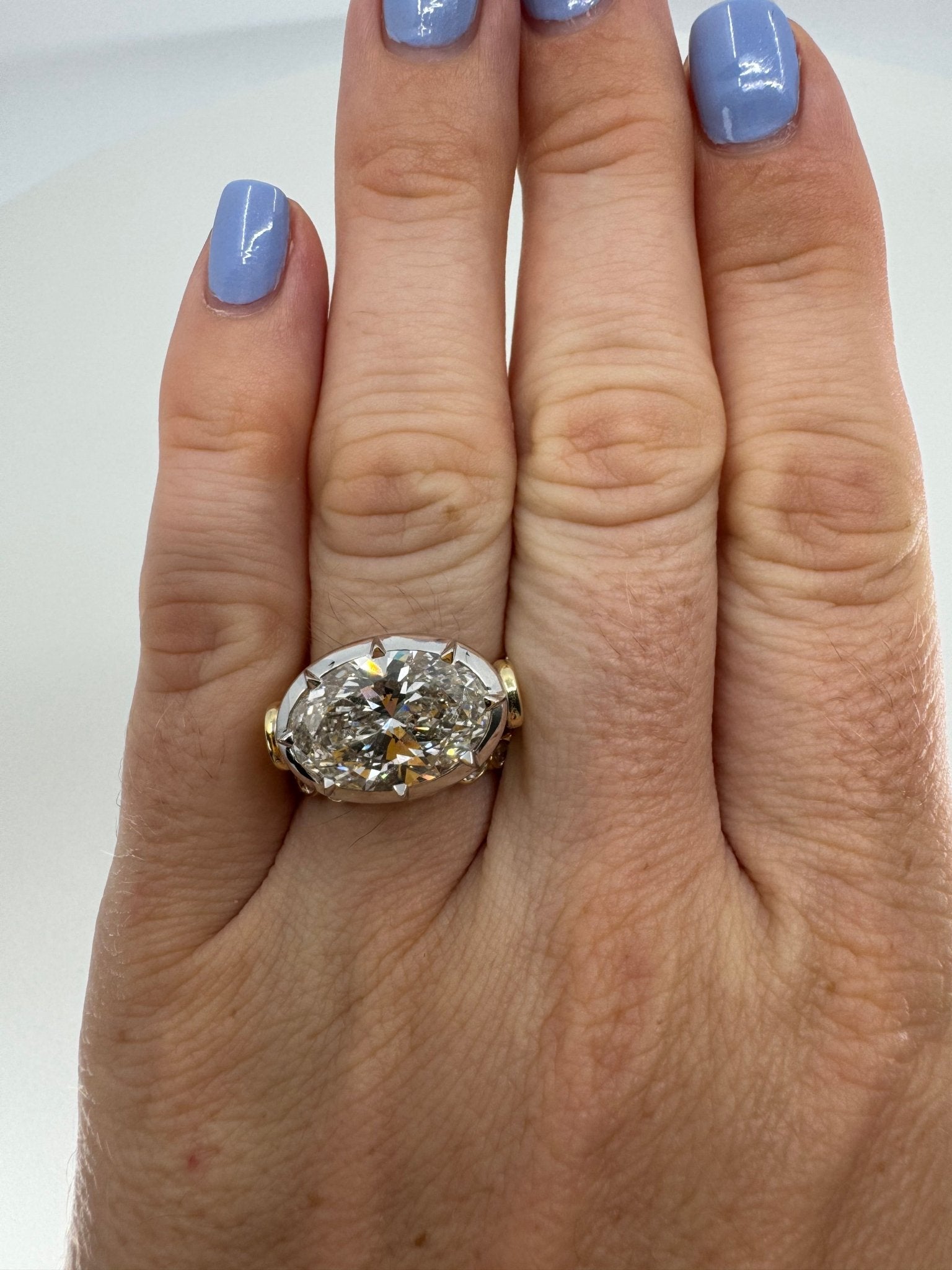 7 carat oval lab grown diamond engagement ring set in two tone collet - Jewelry by Cleo