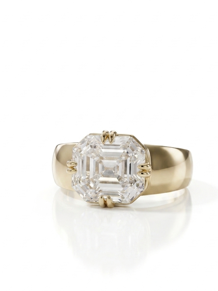 Gold ring with a large diamond on a white background