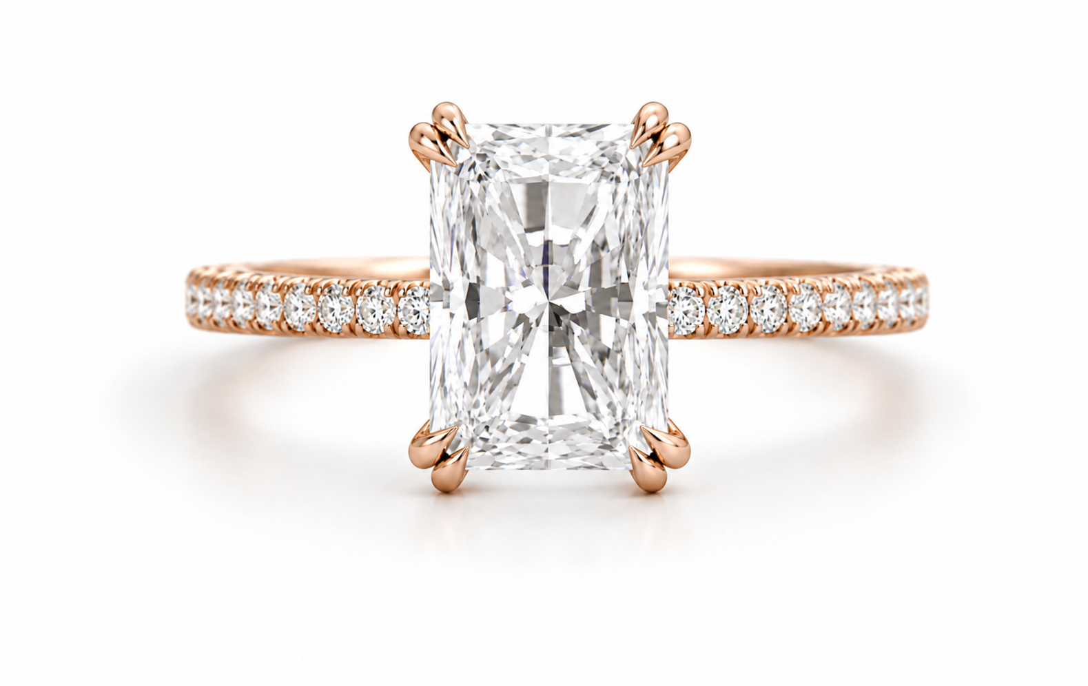 An emerald-cut diamond engagement ring in rose gold with a pavé band, set against a clean white background.
