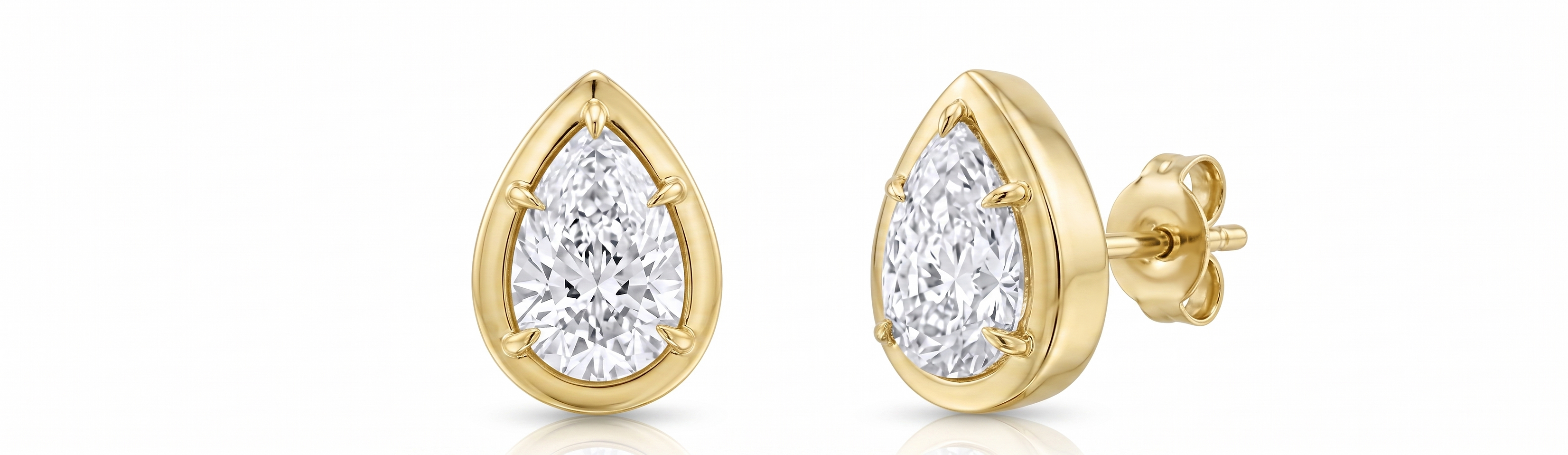 Gold teardrop-shaped earrings with clear gemstones on a white background