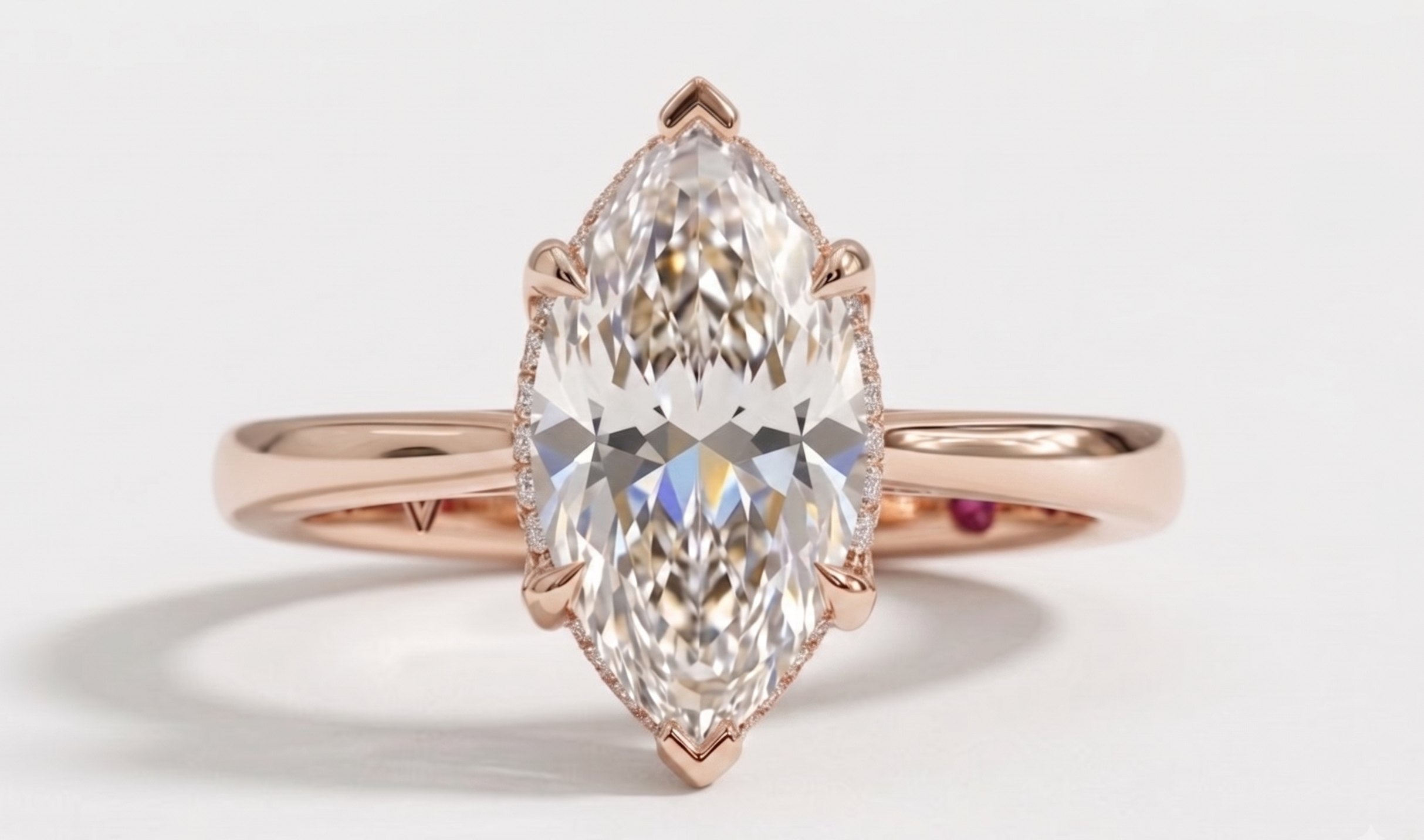 A rose gold ring featuring a large marquise-cut clear gemstone in a prong setting, shown against a clean white background.