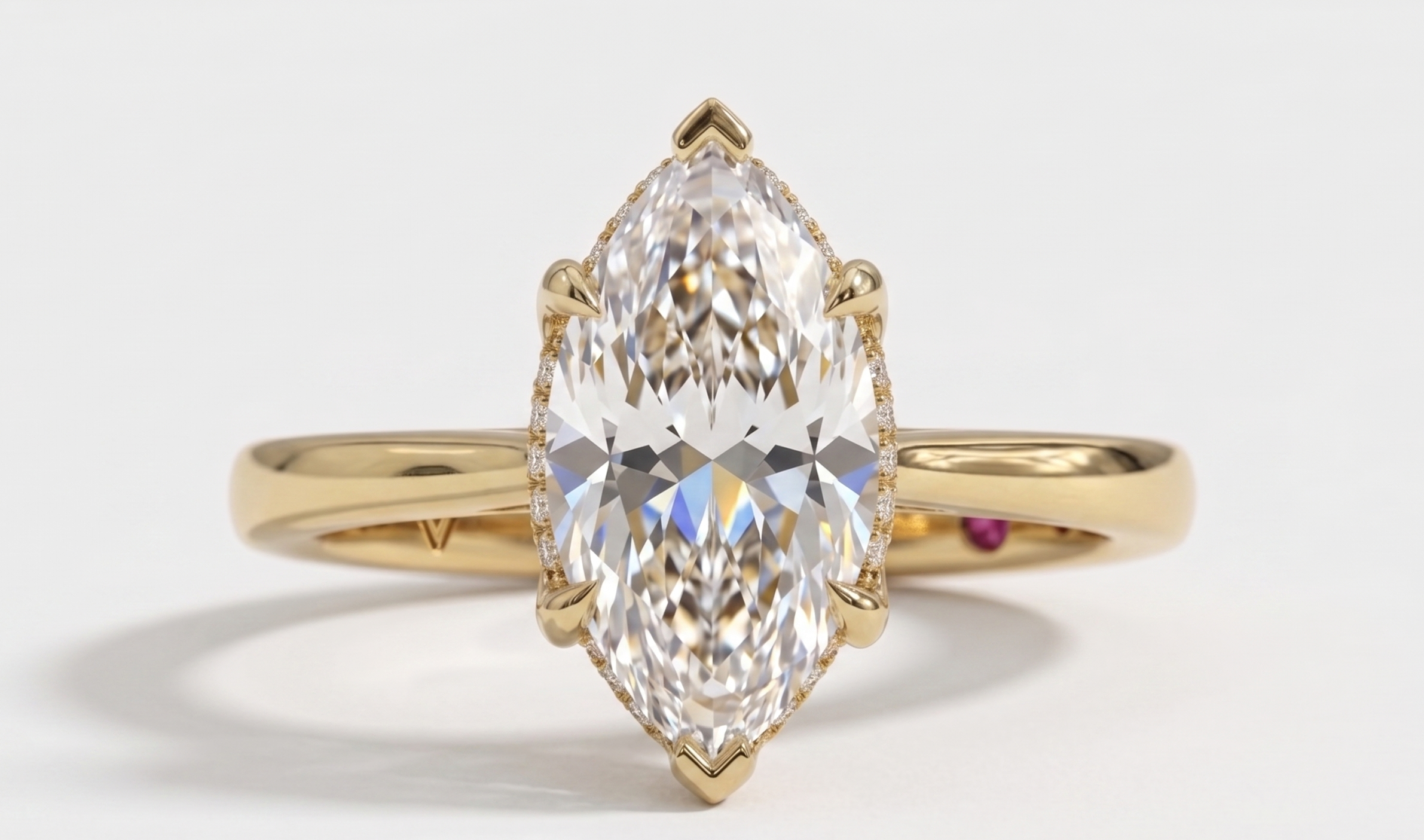 A yellow gold ring featuring a large marquise-cut clear gemstone in a prong setting, shown against a clean white background.