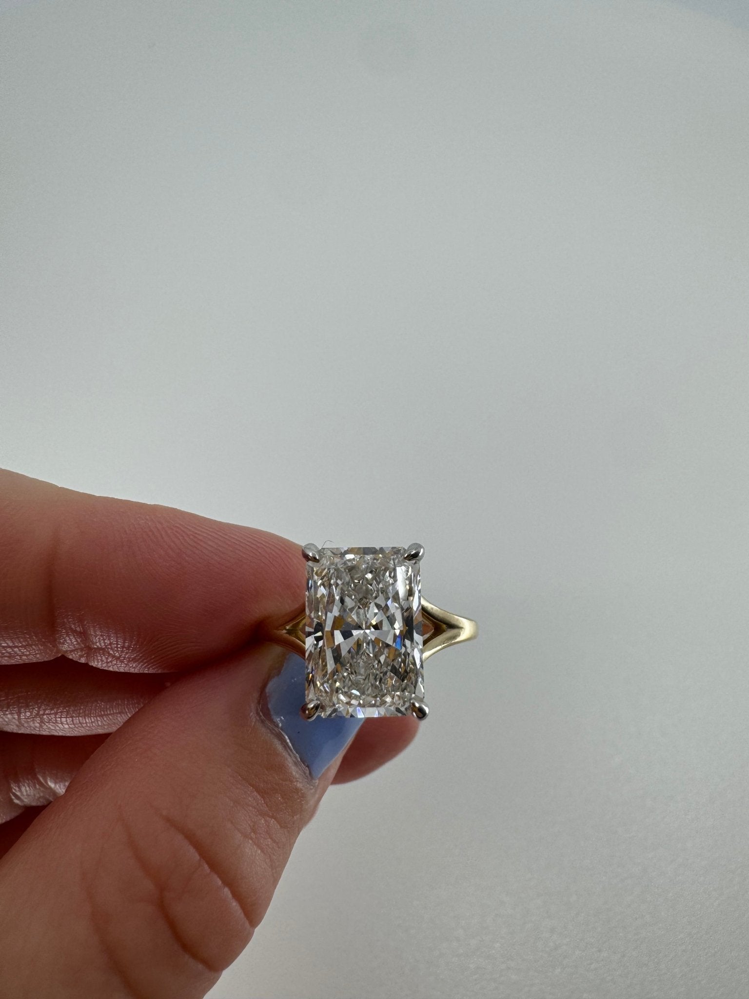 Two tone slight split shank solitaire engagement ring featuring a 5 carat radiant center stone - Jewelry by Cleo