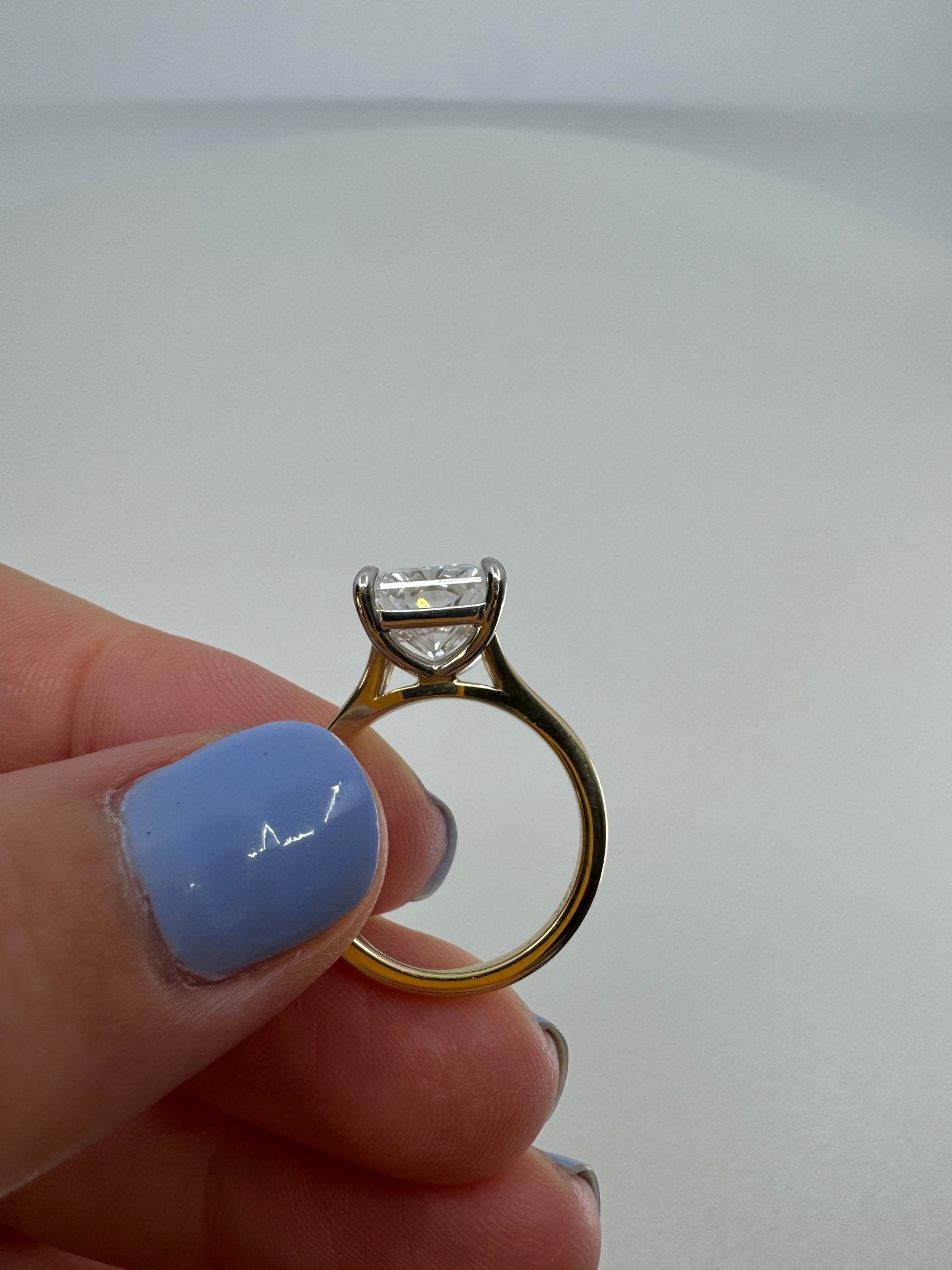 Two tone slight split shank solitaire engagement ring featuring a 5 carat radiant center stone - Jewelry by Cleo
