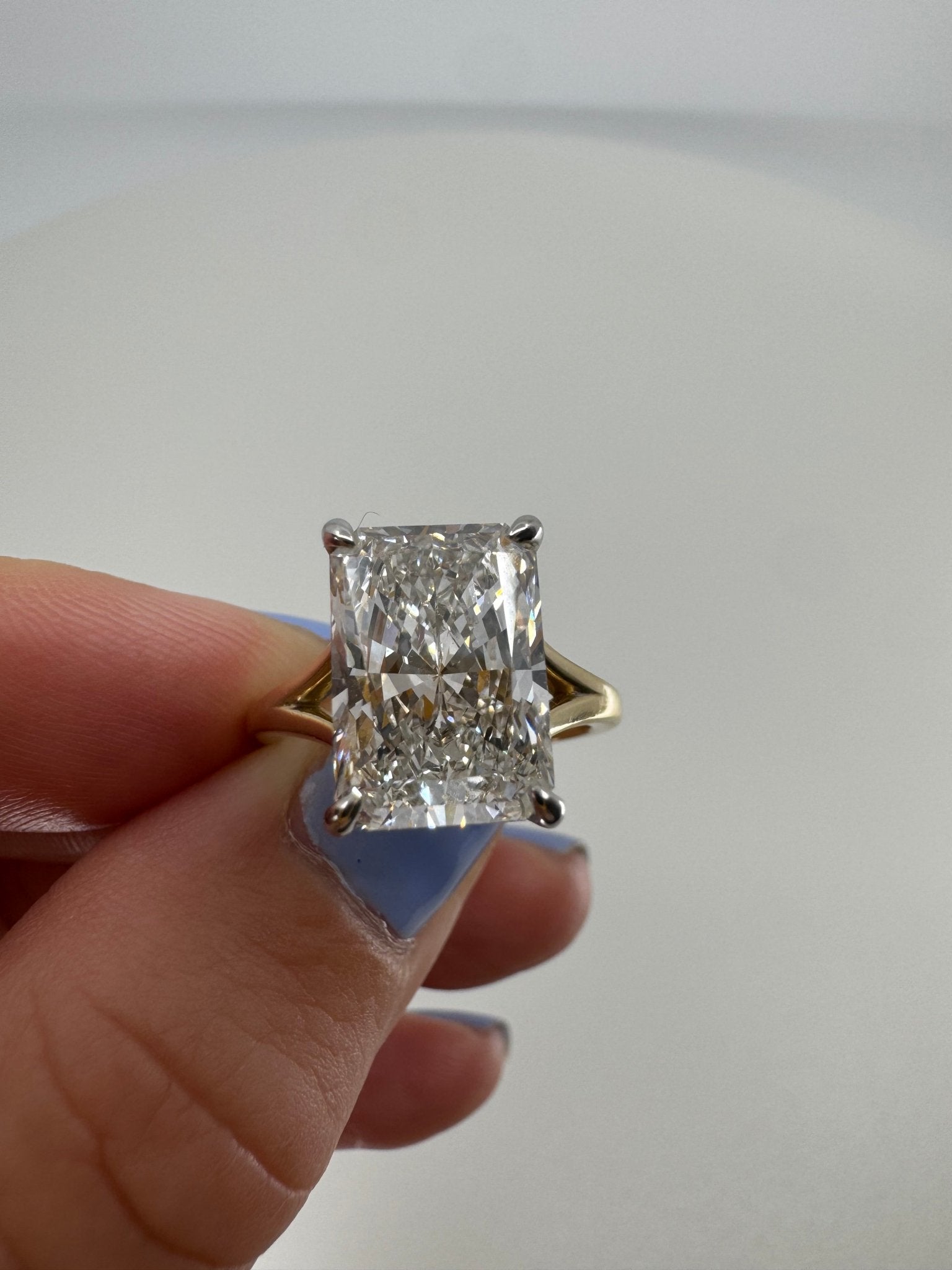 Two tone slight split shank solitaire engagement ring featuring a 5 carat radiant center stone - Jewelry by Cleo