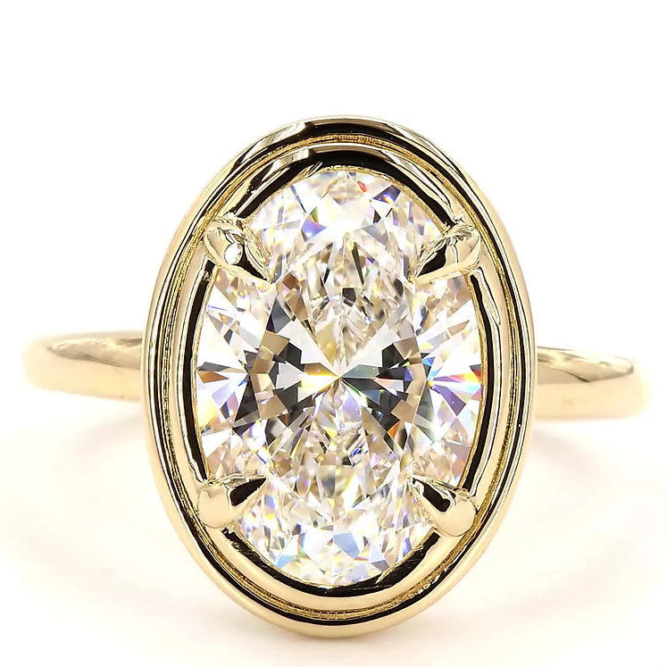 Gold ring with a large diamond on a white background