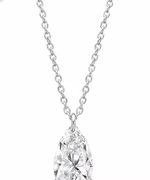 Pear-shaped diamond pendant on a chain against a white background