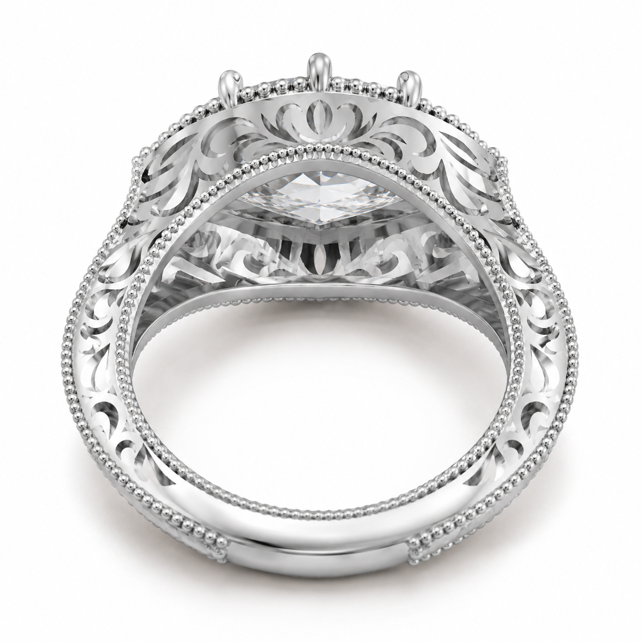 An ornate silver filigree ring with a marquise-cut clear gemstone, shown from a top-down perspective on a white background.