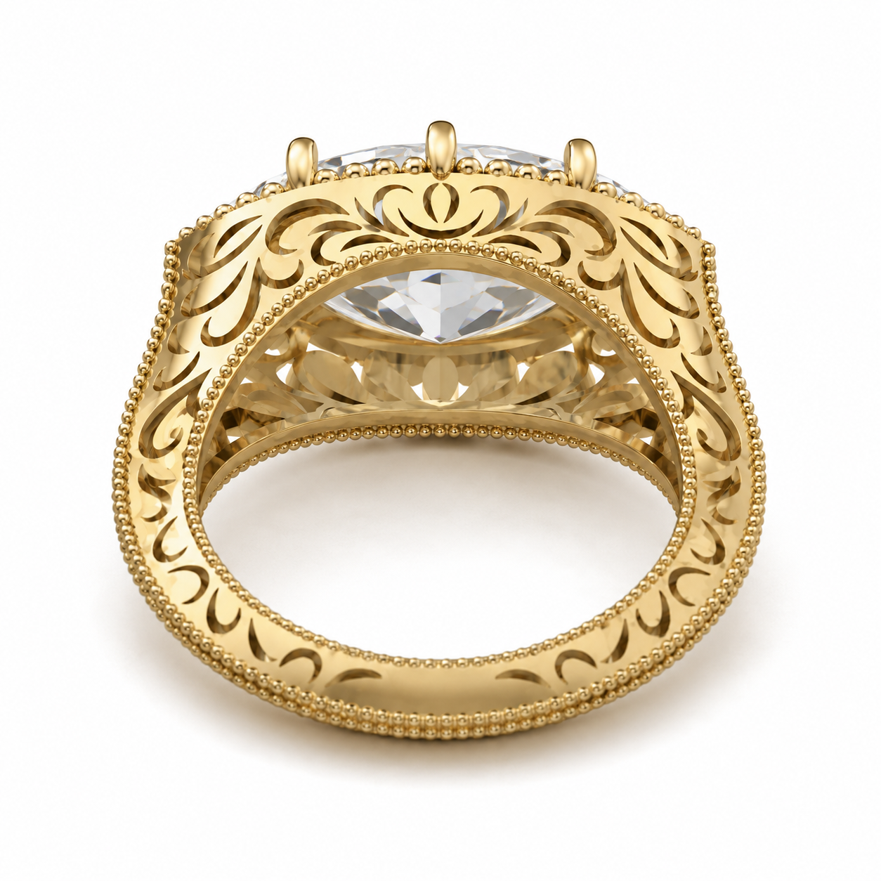 An ornate yellow gold ring with a large clear center stone and intricate filigree detailing on the shank, shown against a plain white background.
