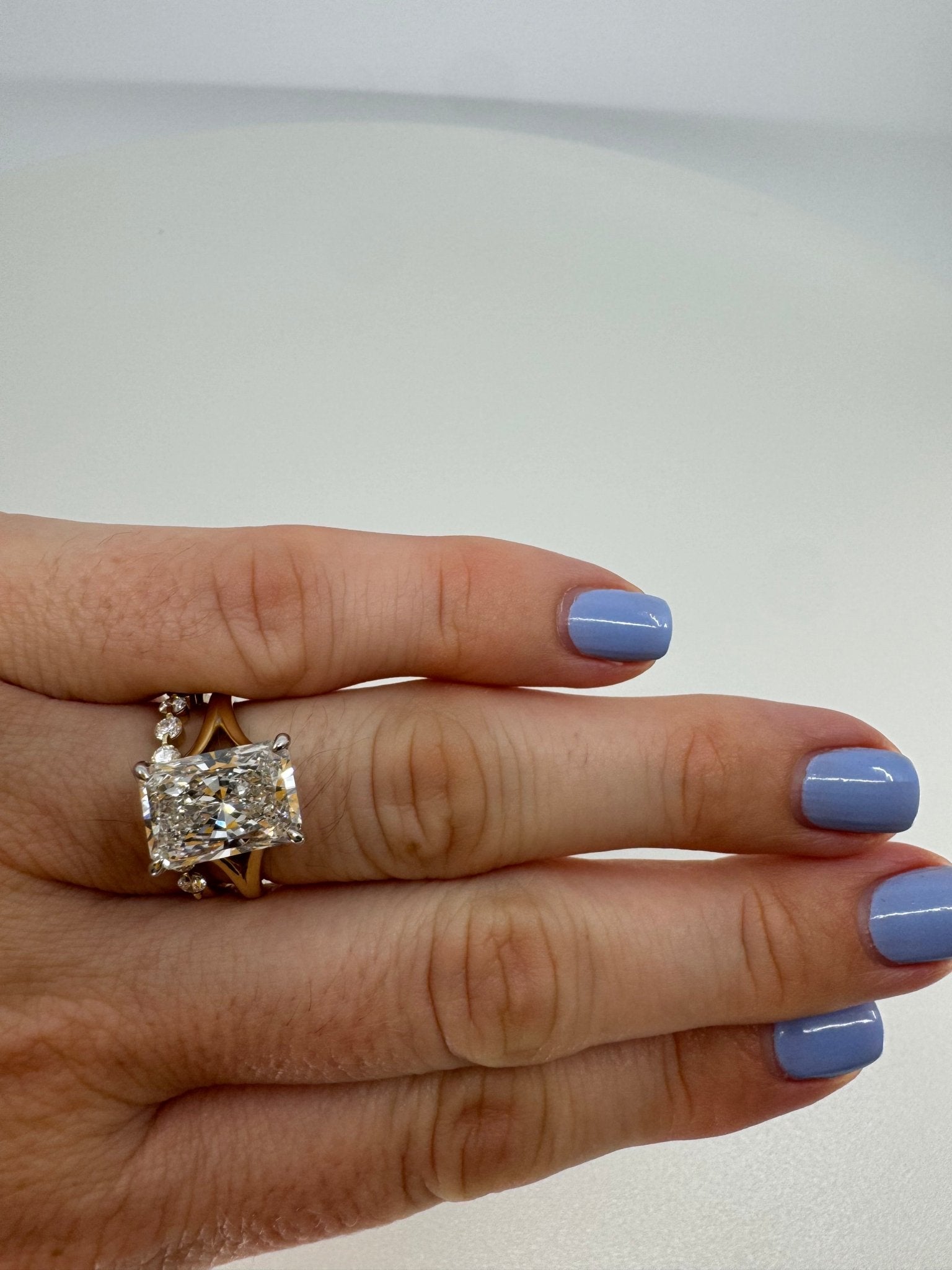 Two tone slight split shank solitaire engagement ring featuring a 5 carat radiant center stone - Jewelry by Cleo